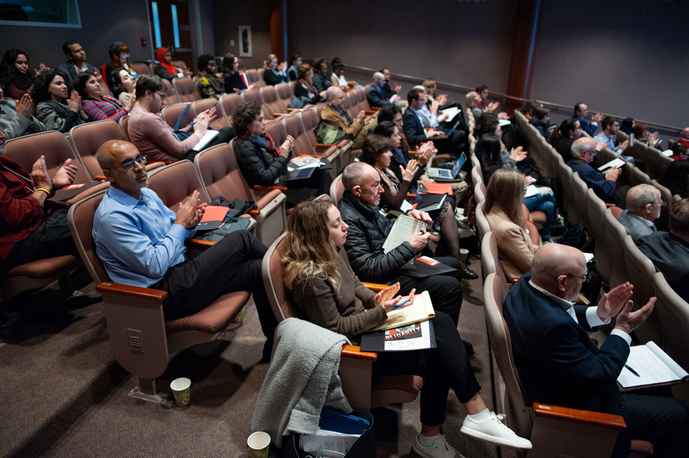 People listening to a lecture in the Dodd Center auditorium