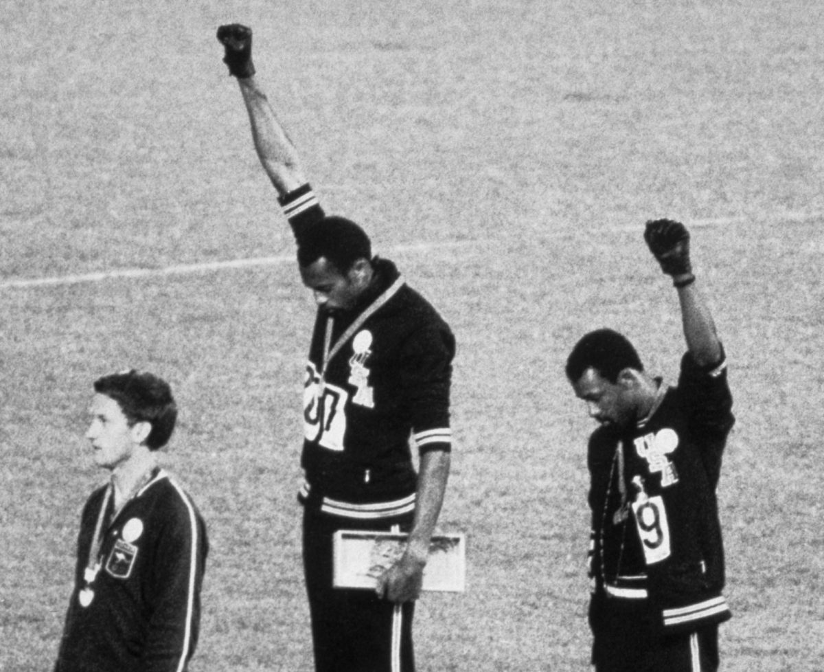 During the award presentation for the Men’s 200-meter event final at the 1968 Summer Olympics, American athletes, gold medalist Tommie Smith (center) and bronze medalist John Carlos (right), each raise a clenched fist and bow their heads during the US National Anthem as a Human Rights protest, while they stand on the podium with Australian silver medalist Peter Norman (1942 - 2006), Mexico City, Mexico, October 16, 1968. All three men wore badges expressing support for the Olympic Project for Human Rights; and Smith and Carlos' gestures have been described (by the men themselves) as both Black Power and Human Rights salutes. Visible at bottom center is the David Cecil, the 6th Marquess of Exeter (1905 - 1981) who presented the medals. (Photo by Bettmann/Getty Images)